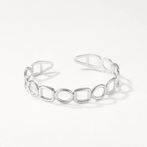 Macro detail of silver geometric hollow-out stainless steel open cuff bracelet