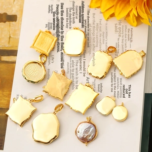 Vintage style gold pendants set with baroque pearls on a floral book background