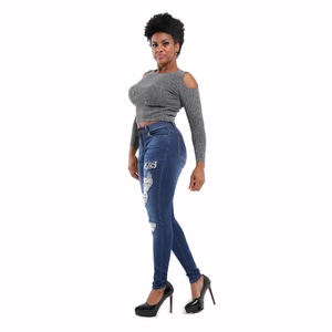 Women's skinny ripped blue denim jeans with fringe hem and grey off-shoulder top