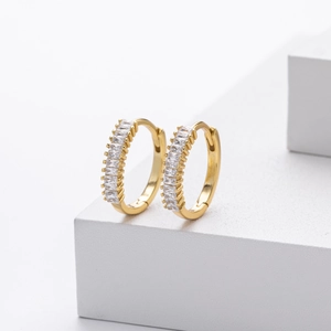 Detailed macro view of gold sterling silver hoop earrings with rectangular cubic zirconia