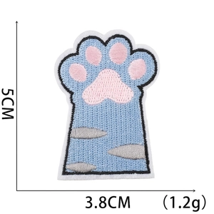 Detail view of light blue embroidered cat paw patch with pink pads and dimensions