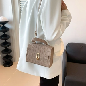 Elegant beige crocodile pattern crossbody bag with golden metal buckle for women
