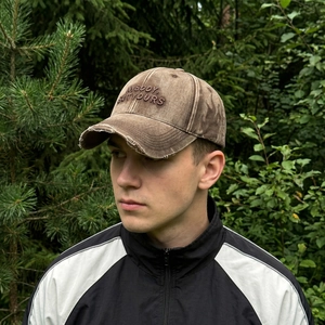 Vintage brown washed baseball cap with distressed brim and embroidered lettering