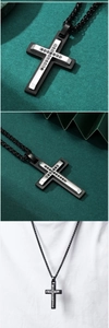 Detail of double-layer titanium steel cross pendant with black stones on green background