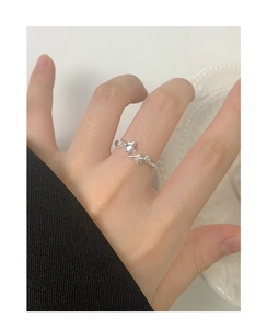 Macro shot of silver S925 adjustable ring with two elegant stars on finger
