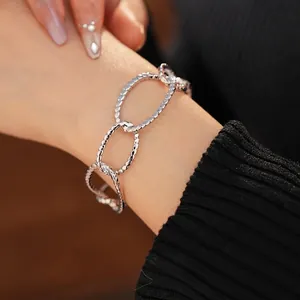 Textured silver chunky chain bracelet with oval links worn by a model in a luxury style