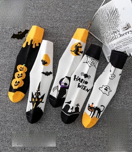 Detail of Halloween crew socks featuring pumpkins, bats, and ghosts in 5 unique patterns