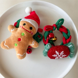 Macro view of Christmas gingerbread man plush and festive red green braided hair ring