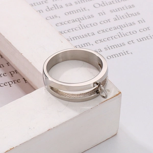 Macro detail of silver stainless steel ring with small loop on a white decorative frame
