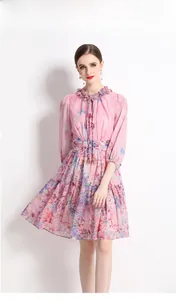 Detail view of pink floral chiffon dress with ruffled collar and lantern sleeves