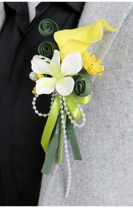 Detail of yellow calla lily and white lily boutonniere on a gray suit for wedding events