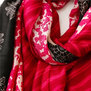 Macro detail of the floral print and soft linen-feel texture on a thick winter shawl