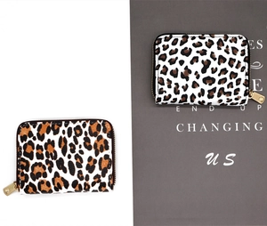 Detail view of leopard print coin purse with durable gold zipper and textured faux leather