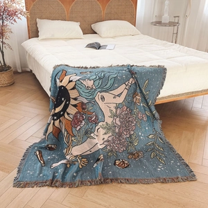 Bohemian woven cotton blanket featuring sun and floral motifs with elegant fringed edges