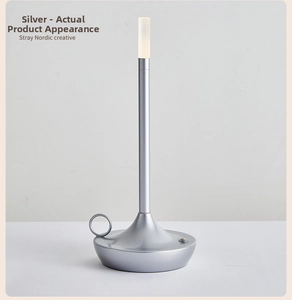 Detail of silver Nordic LED lamp with a ring handle on a conical metal base