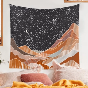 Detail of bohemian tapestry featuring abstract starry sky and mountains in a bedroom