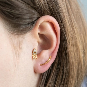 Minimalist gold triangle zircon tassel earrings and ear cuff set worn by model