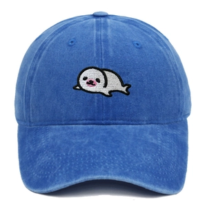 Close-up of cute cartoon seal embroidery on vintage washed navy cotton baseball cap