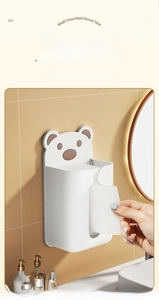 Detail of wall-mounted tissue box featuring a cute bear design and wide paper exit