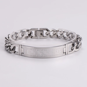 Macro detail of silver stainless steel Cuban chain bracelet with Greek meander pattern plate
