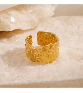 Detail of wide gold hammered texture ring with adjustable open design on crystal stone