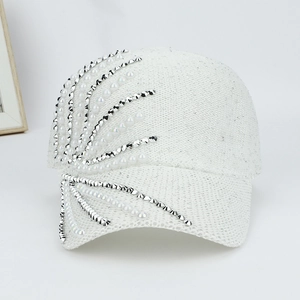 Detail of white baseball cap with sequins, pearls and rhinestones decoration