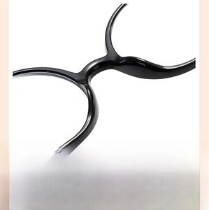 Detail of integrated nose pads on glossy black round frames for children