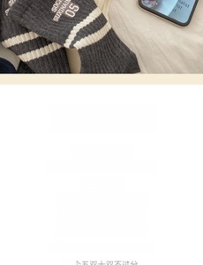 Detail of grey cotton mid-calf sports socks with white stripes and letter embroidery
