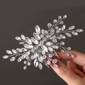 Detail shot of a silver floral bridal hair comb with sparkling rhinestones and alloy base