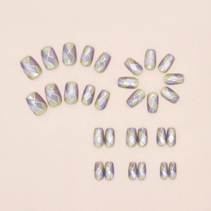 Detail of press on nails with cat eye texture and purple green gold geometric pattern