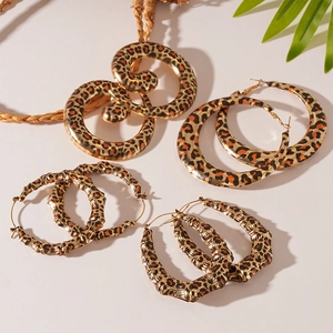 Set of four leopard print hoop earrings in swirl and bamboo styles for women