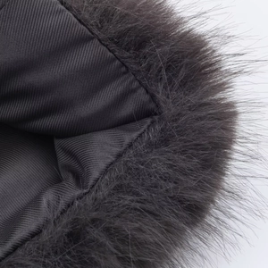 Detailed close-up of dark grey faux fur trim and textured twill lining on winter coat