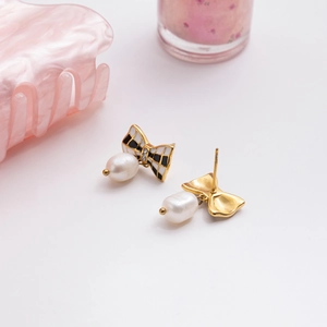 Elegant bow earrings with black and white enamel, crystals and baroque pearls in gold finish