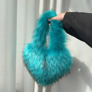 Detailed view of the soft faux fur texture on this teal heart shaped shell handbag