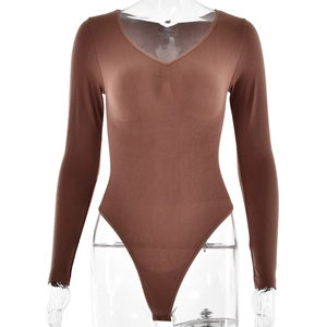 Detail of brown ribbed knit long sleeve bodysuit showing v-neckline and elastic texture
