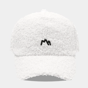 Close-up of white fleece baseball cap with black mountain embroidery and soft texture