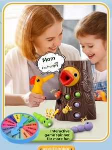 Detailed view of mother and child playing with magnetic woodpecker bird feeding toy