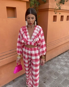 Detail of pink plaid V-neck cropped top with ruffle sleeves and matching trousers