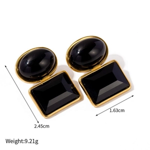 Detail view of gold vintage earrings with black stones showing dimensions 2.45cm by 1.63cm