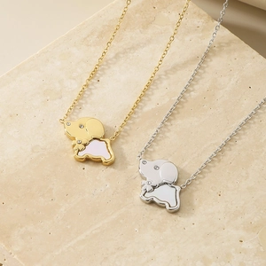 Detail of dog pendant necklaces in gold and silver finish with sparkling rhinestones