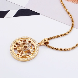 Detailed view of hip hop gold skull pendant with sparkling rhinestones and rope chain