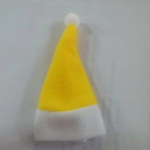 Close-up of mini yellow Christmas hat decoration for wine bottles or tableware