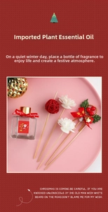 Macro detail of Christmas reed diffuser set with festive red ribbon and holiday charms