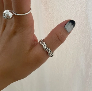 Close-up of minimalist S925 sterling silver irregular and twisted rope texture rings