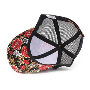 Detail view of breathable black mesh and vibrant floral print on polyester trucker hat
