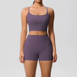 Detail of cross-back yoga set with thin straps sports bra and high-waisted shorts in mauve