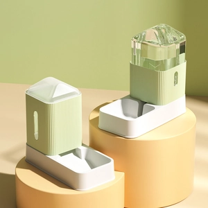 Automatic gravity pet feeder and water dispenser set in mint green on modern podiums