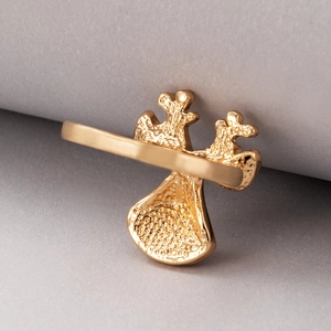 Close-up of golden alloy Christmas ring showing unique irregular coral-like metal texture