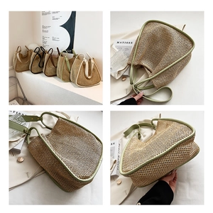 Close-up detail of woven straw tote bag with reinforced faux leather handles and texture