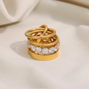 Macro shot of 18K gold plated multi-layer ring with sparkling cubic zirconia on silk